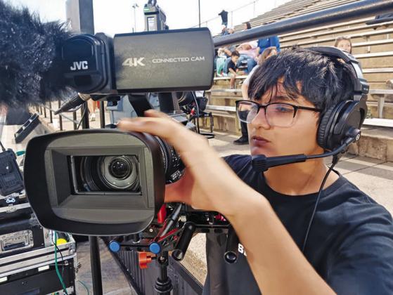 Liberty High School junior Jose Becerra sets up a camera for a Panther Sportz Network broadcast of a football game. Contributed Photo