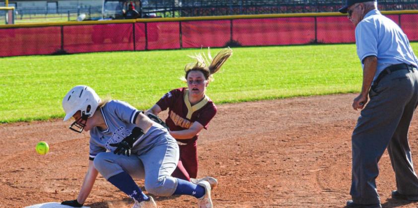 Hardin’s Taylor Knight avoids the tag of Tarkington third baseman Emily Lowe on this triple on Friday night in district action The Vindicator | Jerry Michalsky Article Image Alt Text