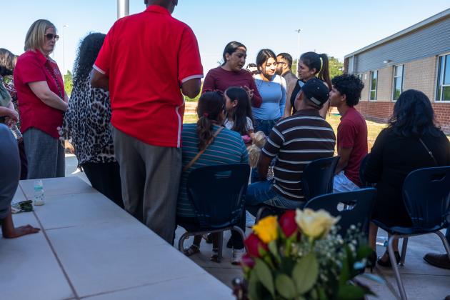 Wilson Garcia, who lost both his wife and son, is comforted by community members following a vigil at Northside Elementary on Sunday. Article Image Alt Text