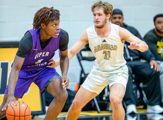Anahuac's Cullen Cotton defends a Viper Squids player last Tuesday at the Liberty Panthers Classic. Photo by Chris Cody Article Image Alt Text
