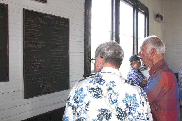 St. Stephen’s Episcopal Church organist Marshall Maxwell (left) and member Ed Seymour look at a list of sponsors of the church, both donors and honorees. Article Image Alt Text