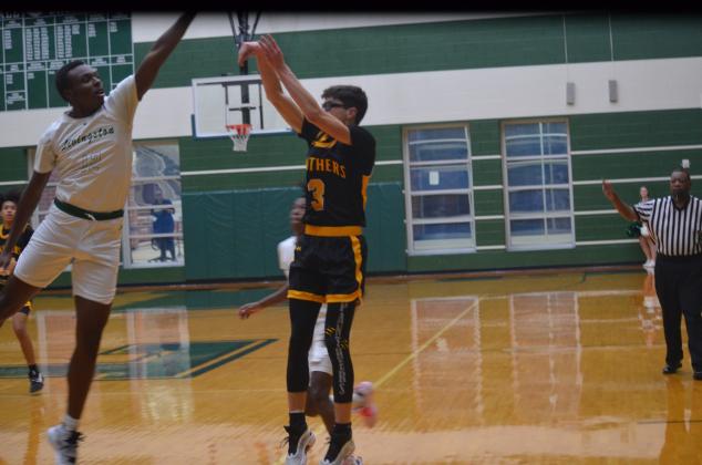 Liberty's Patrick Flowers nails a three-pointer at Livingston on Wednesday night in district action. Article Image Alt Text