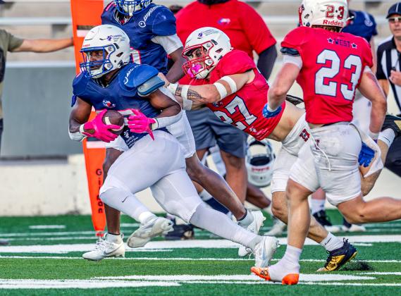 Anahuac's Tyler Kelly (27) makes the stop on an East player during the SETCA All-Star Football game at Lamar University. Article Image Alt Text