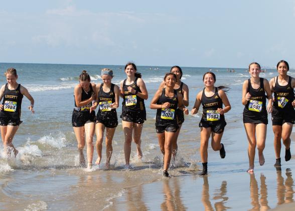 The Lady Panthers Cross Country squad runs in the Galveston Ball Beach Run. 