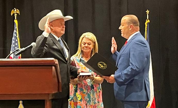 Chambers County Sheriff Brian Hawthorne (left), takes the oath as president of the Sheriffs' Association of Texas, was joined by his wife, County Clerk Heather Hawthorne, holding a Bible at the 147th Annual Training Conference and Expo in Fort Worth last week. Article Image Alt Text