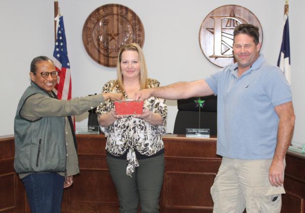 City Secretary Jennifer Billings holds the basket as former Dayton City Council members Sherial Lawson and Josh Townsend draw for a place on the May 6 ballot. Lawson won the luck of the draw and will appear first. Article Image Alt Text