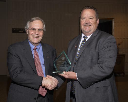 Larry Norwood is presented the 2021 Lamar University Distinguished Alumnus award by Dr. Brian Craig, Dean of the College of Engineering, Photo Credit: Brandon Gouthier Article Image Alt Text