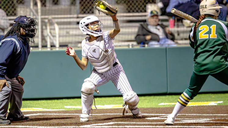 Anahuac Lady Panthers catcher Gabriella Palacios keeps a high-thrown pitch in hand last week on the road at East Chambers. Article Image Alt Text