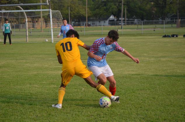 Liberty's Alberto Diaz tries to get the ball away from a Lumberton player on Friday night at Memorial Stadium. Article Image Alt Text
