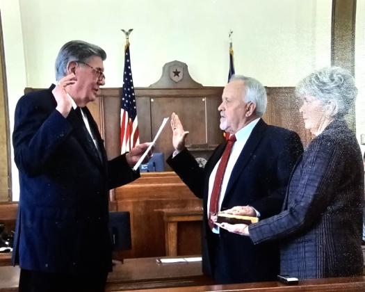 Former Liberty County Judge Lloyd “ Tookie” Kirkham administers the oath of office to current County Judge Jay Knight. Kirkham is being remembered as a friend and mentor who loved his community. Article Image Alt Text