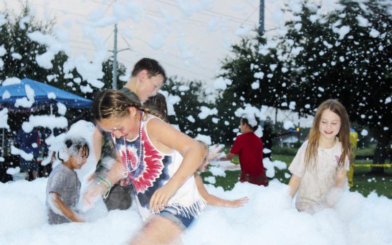 Kiddos enjoy playing in bubbles at Dayton’s Hometown Celebration at the Dayton Community Center. Photo by Celeste Denova